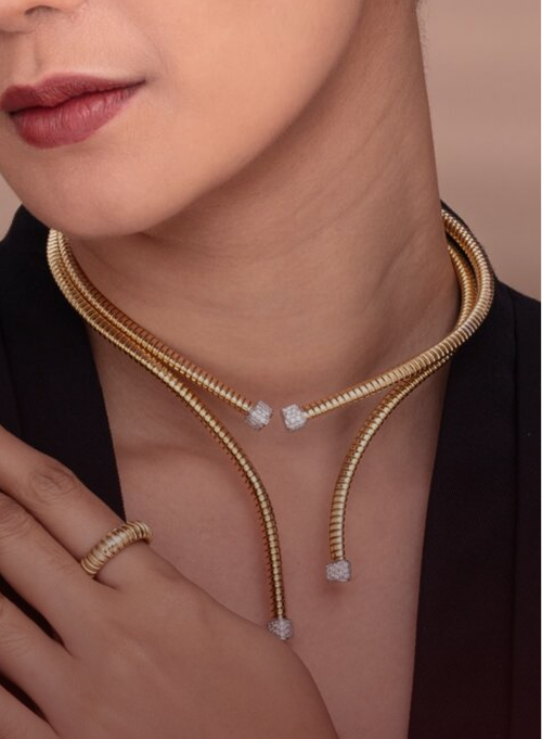 Gold Necklace by Golds and Stones worn by a woman.